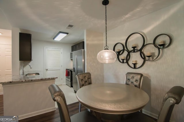 dining room featuring dark hardwood / wood-style floors and sink