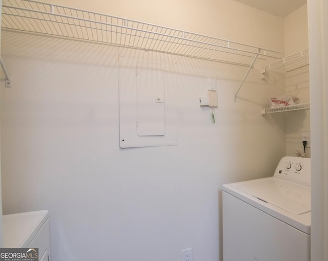 washroom with electric panel and washer and dryer