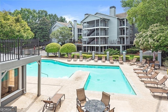 view of swimming pool featuring a patio area