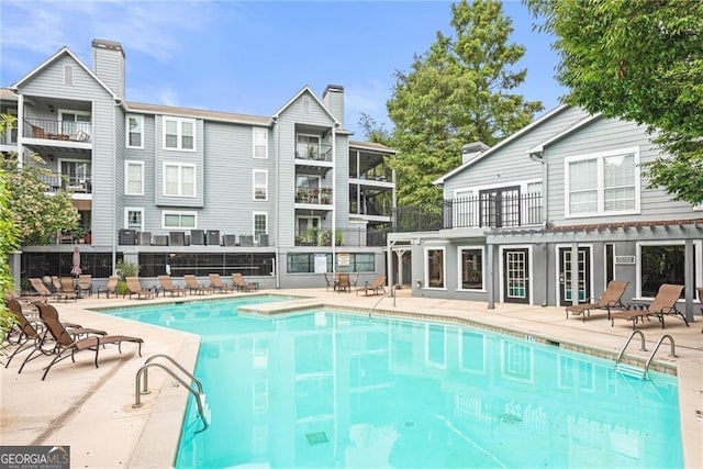 view of swimming pool featuring a patio area