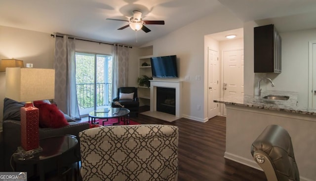 living room featuring ceiling fan, lofted ceiling, dark hardwood / wood-style floors, and sink