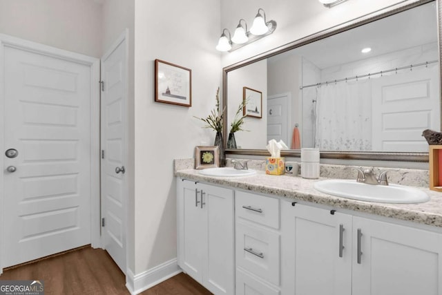 bathroom featuring vanity, hardwood / wood-style floors, and a shower with curtain