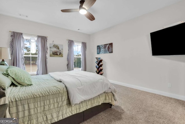 bedroom with ceiling fan, carpet flooring, and multiple windows