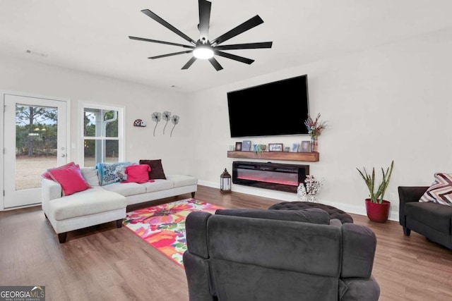 living room featuring ceiling fan and hardwood / wood-style floors