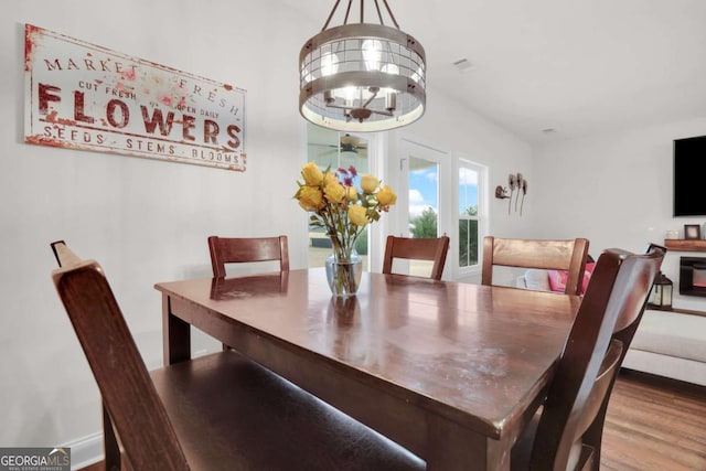 dining room with an inviting chandelier and hardwood / wood-style floors