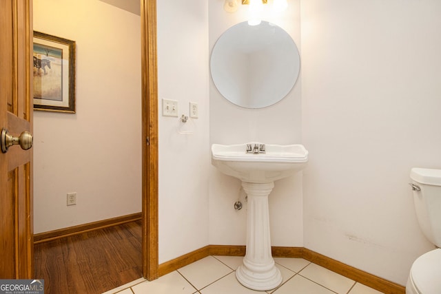 bathroom with toilet and tile patterned flooring