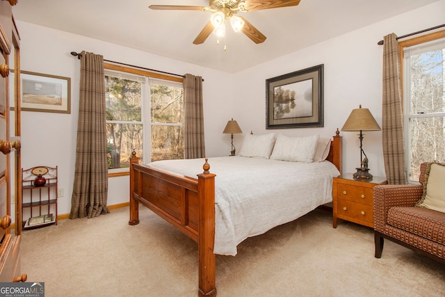 bedroom with light carpet and ceiling fan