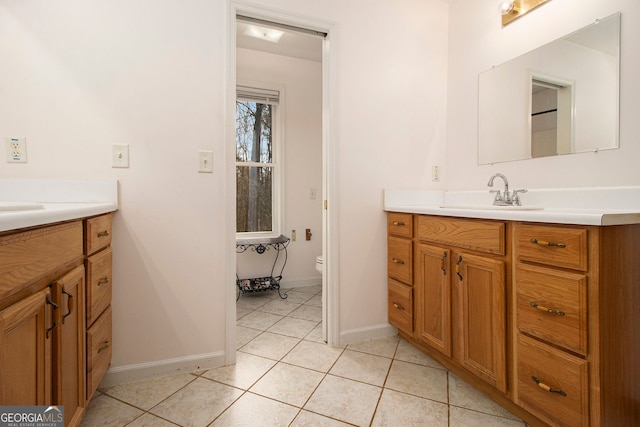 bathroom featuring tile patterned flooring, vanity, and toilet