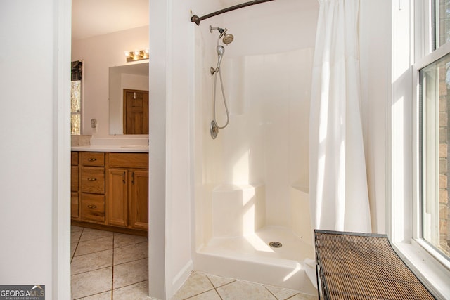 bathroom featuring vanity, tile patterned floors, and walk in shower