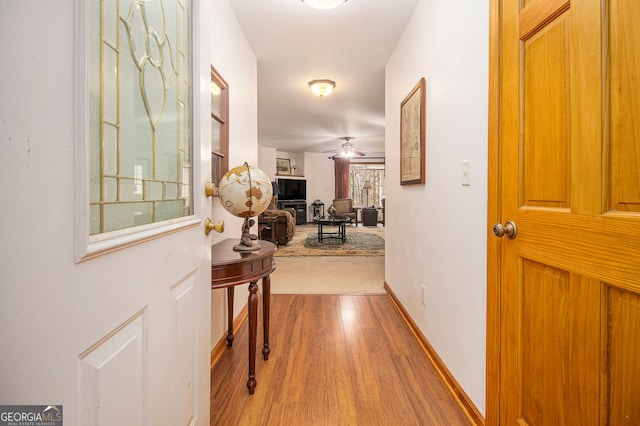 corridor with hardwood / wood-style floors