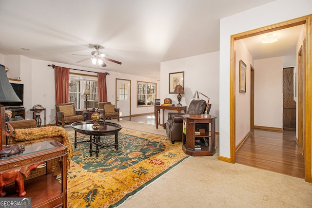 living room featuring carpet floors and ceiling fan