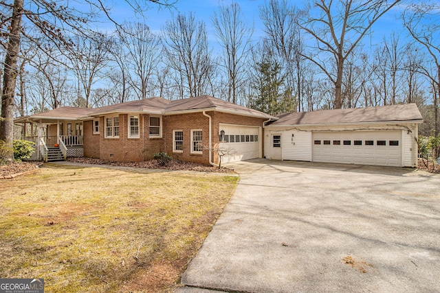 ranch-style home with a garage, covered porch, and a front lawn