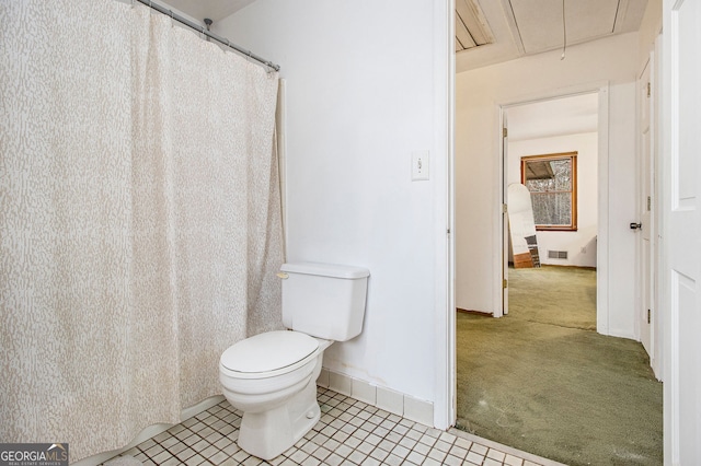 bathroom with tile patterned flooring and toilet