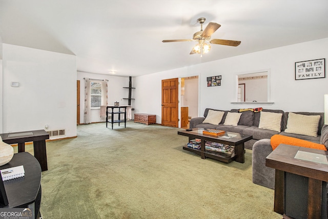 carpeted living room with ceiling fan