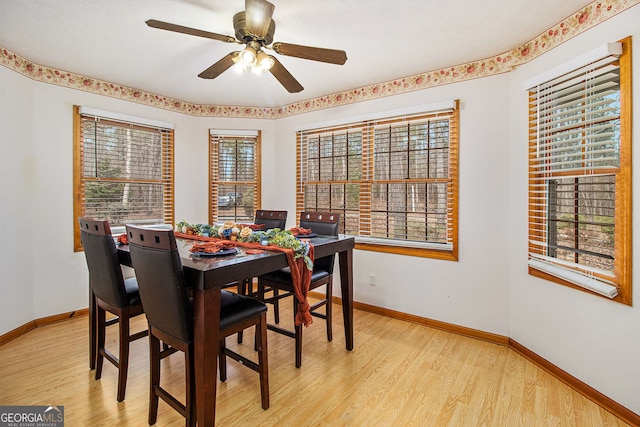 dining space with ceiling fan and light hardwood / wood-style floors