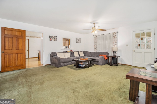 carpeted living room with ceiling fan