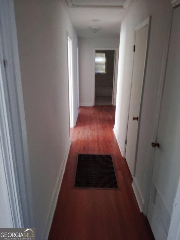 hallway featuring dark hardwood / wood-style flooring