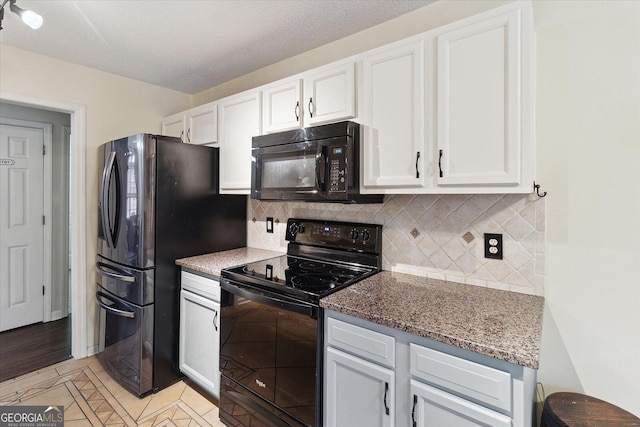 kitchen with tasteful backsplash, dark stone countertops, white cabinets, black appliances, and a textured ceiling