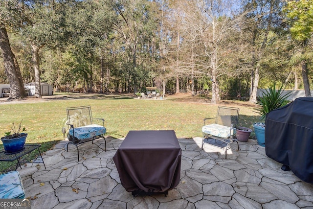 view of patio with grilling area and a storage shed