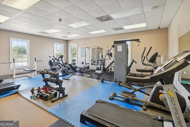 gym with a paneled ceiling