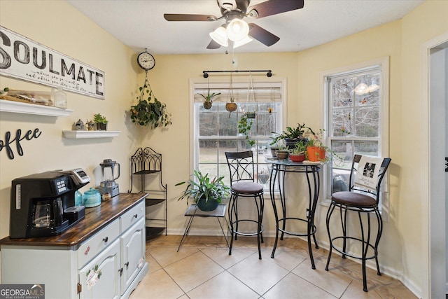 dining room featuring ceiling fan and light tile patterned floors