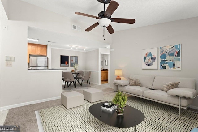 carpeted living room featuring ceiling fan