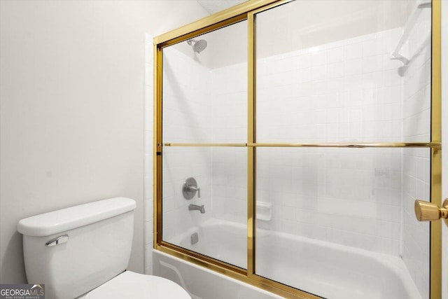 bathroom with shower / bath combination with glass door and toilet