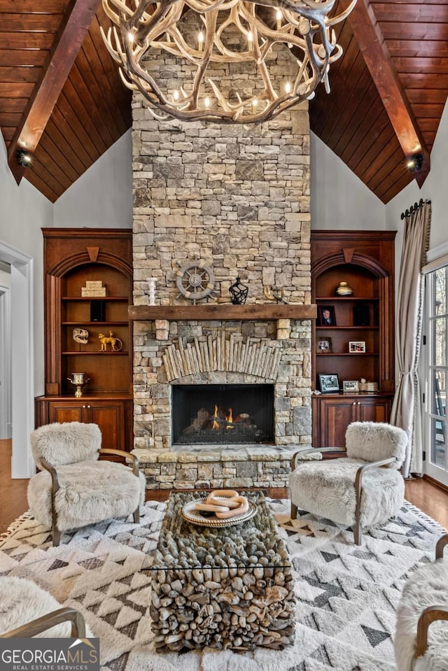 living room with hardwood / wood-style flooring, wooden ceiling, a fireplace, and lofted ceiling with beams