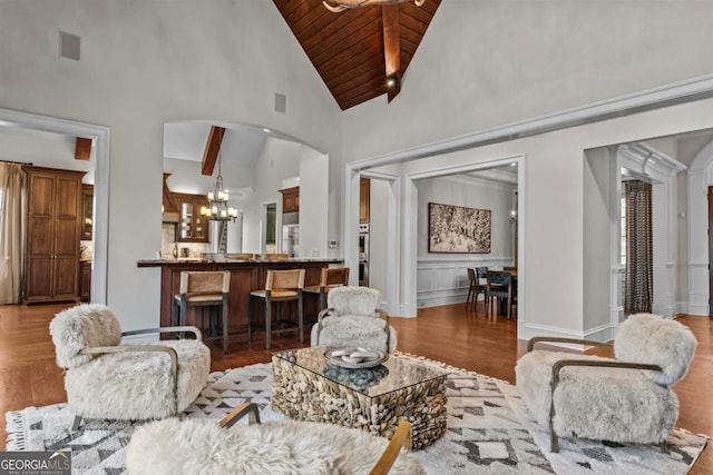 living room featuring high vaulted ceiling, wooden ceiling, a chandelier, and light wood-type flooring