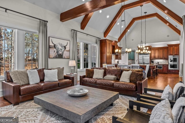 living room featuring beam ceiling, light hardwood / wood-style flooring, high vaulted ceiling, and a chandelier