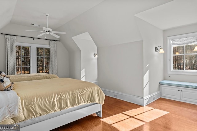 bedroom featuring lofted ceiling and light hardwood / wood-style flooring