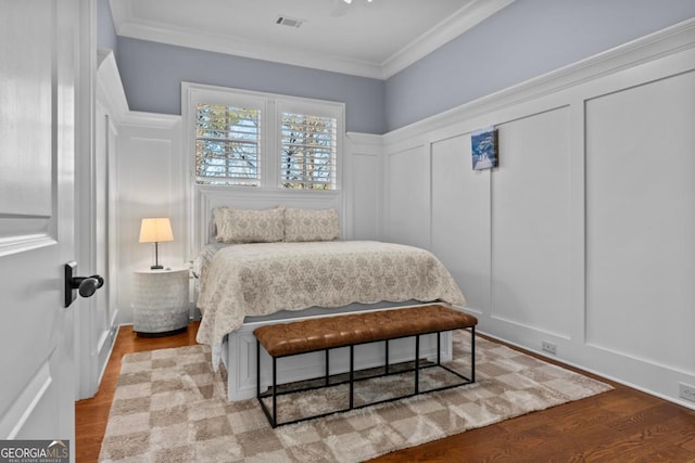 bedroom featuring crown molding and light wood-type flooring