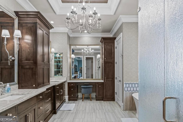 bathroom with a bathing tub, ornamental molding, vanity, a notable chandelier, and a tray ceiling