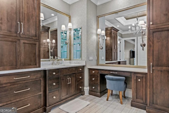 bathroom with vanity, a notable chandelier, and ornamental molding