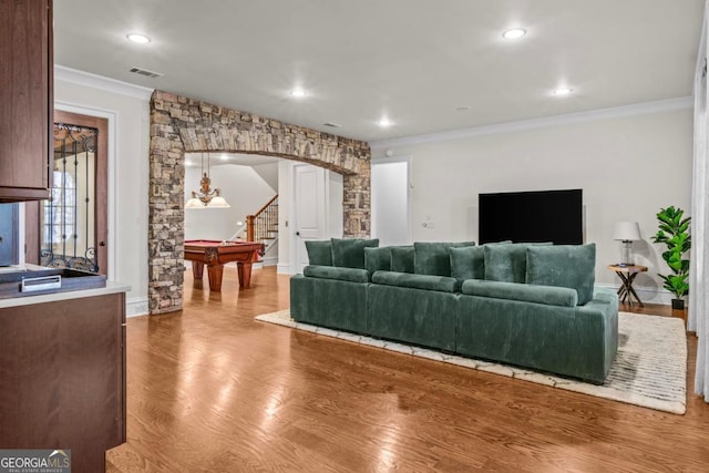 living room with hardwood / wood-style floors and ornamental molding