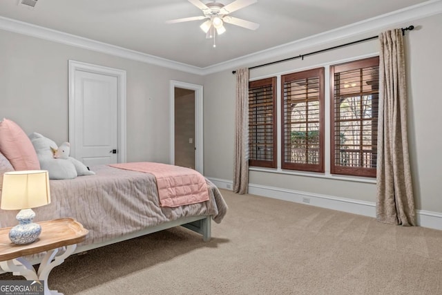 carpeted bedroom featuring ornamental molding and ceiling fan