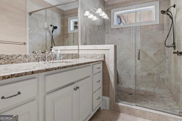 bathroom featuring a shower with door, vanity, and tile patterned flooring