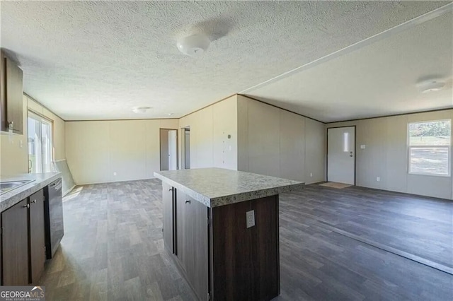 kitchen with dark wood-style flooring, open floor plan, dishwasher, and a center island