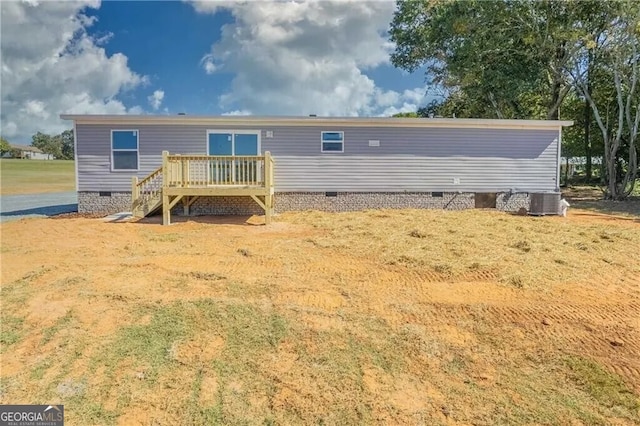 rear view of house featuring crawl space and a wooden deck