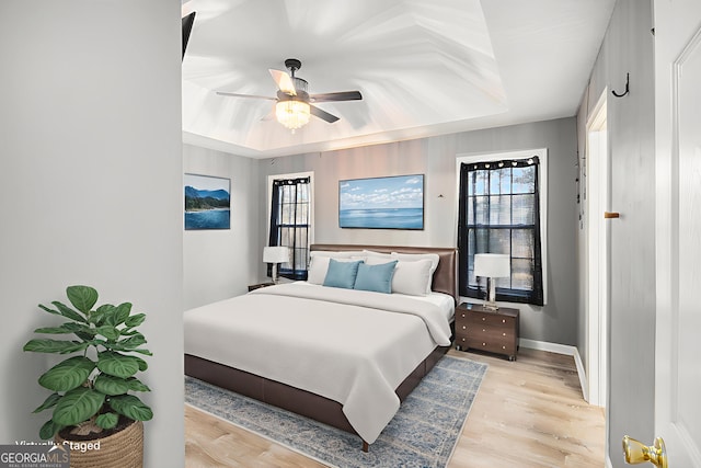 118 Gilberts Way, Temple, GA 30179 - bedroom with a raised ceiling, light wood-style floors, ceiling fan, and baseboards