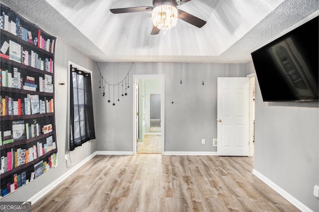 118 Gilberts Way, Temple, GA 30179 - unfurnished bedroom featuring wood finished floors, a raised ceiling, baseboards, and a textured ceiling
