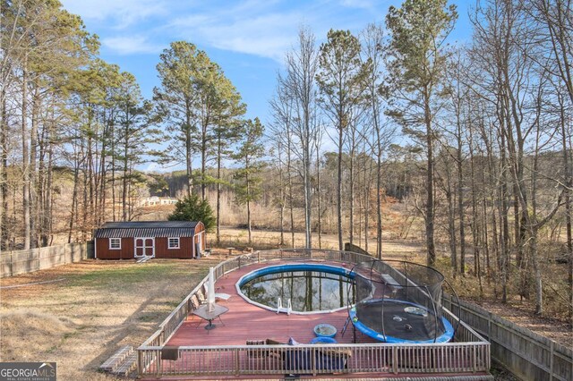 118 Gilberts Way, Temple, GA 30179 - view of pool with an outbuilding, a deck, and a trampoline