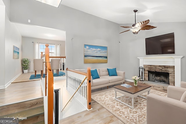 118 Gilberts Way, Temple, GA 30179 - living area with ceiling fan, wood finished floors, baseboards, and a fireplace