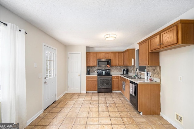 118 Gilberts Way, Temple, GA 30179 - kitchen featuring stainless steel microwave, range with electric cooktop, a sink, decorative backsplash, and brown cabinetry