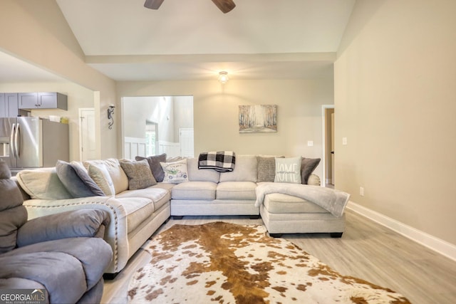 living room with light hardwood / wood-style floors and ceiling fan