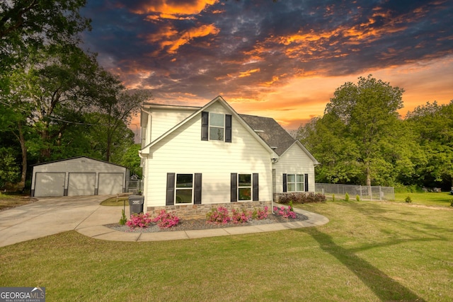 view of front of home with an outbuilding, a garage, and a lawn