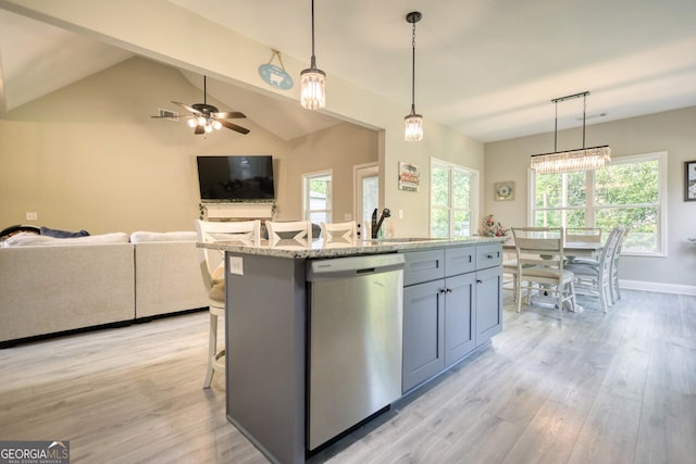 kitchen with dishwasher, a kitchen island with sink, and hanging light fixtures