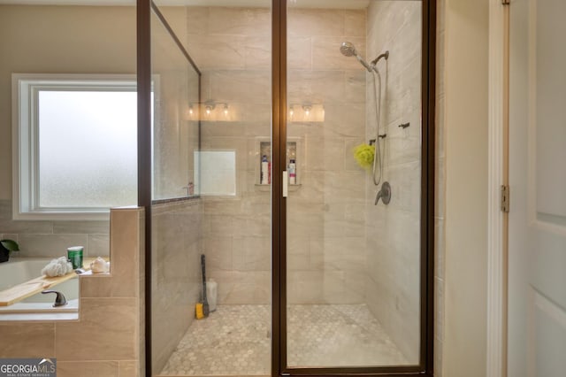 bathroom featuring independent shower and bath