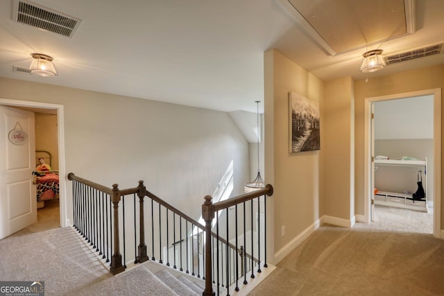 corridor featuring light colored carpet