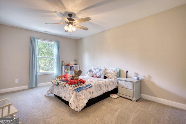 bedroom featuring light colored carpet and ceiling fan